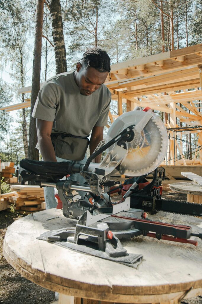 Temp worker using a table saw. Worker for staffing agency doing construction.
